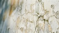 Weathered white painted wall surface with peeling paint and cracked texture, suitable for backgrounds, overlays, and grunge design projects.