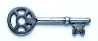 Vintage antique metal skeleton key isolated on white background, symbol of security, access, and mystery for retro design projects.