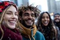Group of diverse young adults laughing together outdoors in winter clothing during holiday season celebration in urban setting.