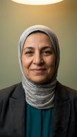 Professional Middle Eastern businesswoman wearing hijab and suit smiling confidently in modern office setting for corporate diversity and inclusion campaigns.