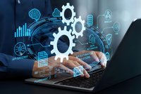Business professional using laptop with digital automation technology interface displaying gears and data analytics for workflow optimization solutions.