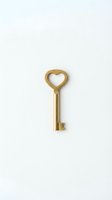 Golden brass key with heart-shaped bow isolated on white background, symbolizing love, romance, and security for Valentine's Day and wedding designs.