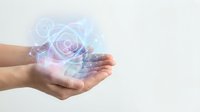 Cupped hands holding glowing holographic email symbols with digital light effects for technology and communication concepts.