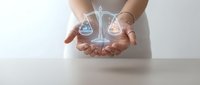 Woman holding glowing scales of justice hologram, symbolizing legal balance, fairness, and ethical business practices for law and compliance concepts.