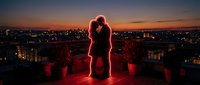 Romantic couple silhouette kissing on rooftop terrace at sunset with city skyline view. Valentine's Day love concept for greeting cards and social media.