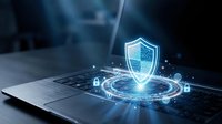 Cybersecurity shield hologram emerging from laptop keyboard with glowing digital protection icons and network connections in futuristic blue technology environment.