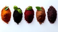 Colorful spice powders arranged in row with fresh basil leaves - turmeric, black pepper, paprika, cinnamon and sumac on white background. Food ingredients pattern.