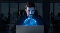 Young Caucasian businessman working late at night with glowing holographic earth globe projection from laptop in dark modern office environment.