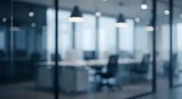 Blurred modern office conference room with glass walls and meeting table for business presentations and corporate meetings background.