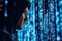 Hooded male hacker in dark clothing digital numbers falling on screen, side view profile in shadows.