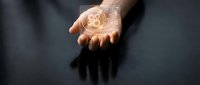 Close-up of a hand displaying a glowing gear icon, representing technology, innovation, and digital transformation for business and industrial concepts.