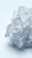 Transparent ice cubes with crystalline structure stacked together on white background, suitable for beverage, food and drink photography.