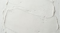 Textured white paint surface with thick brushstrokes and impasto technique creating abstract artistic background for creative projects and design work.