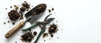 Gardening tools with scattered soil and dirt on white background, suitable for landscaping, horticulture, and garden design projects.