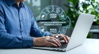 Professional businessman working on laptop with OODA loop continuous improvement feedback cycles diagram overlay for business strategy and process optimization.
