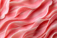 Soft pink wavy texture with gentle flowing curves and smooth undulating surface creates abstract organic pattern. Light and shadows add depth to delicate folds.