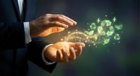 Businessman hands protecting glowing green recycling symbol with magical light effects representing environmental sustainability and eco-friendly business practices.