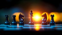 Chess pieces silhouetted against dramatic orange sunset background with king piece centered, reflecting on glossy surface in blue and golden light.