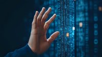 Hand reaching toward digital data stream with binary code on dark blue background, representing cybersecurity or digital transformation in technology.