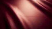 Smooth burgundy silk fabric with soft light reflections creating an elegant, luxurious textile background for design and branding projects.