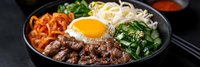 Korean bibimbap bowl with marinated beef, fried egg, kimchi, rice noodles and fresh greens served in black ceramic bowl on dark background.