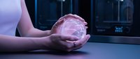 Hands holding glowing pink holographic sphere with digital interface in modern tech environment for futuristic business and innovation concepts.