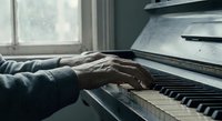 Elderly hands playing piano keys in soft natural light from window, senior musician practicing classical music at home, artistic black and white photography.