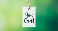 White paper tag with You Can motivational message hanging on twine string against soft green gradient background for inspiration and encouragement concepts.