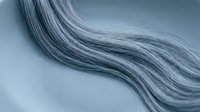 Flowing silver gray hair strands with natural wave texture and movement against soft blue background for beauty and haircare concepts.