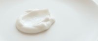 Creamy white cosmetic product swirl isolated on white background, ready for skincare packaging, beauty advertising, and wellness design projects.