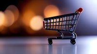 Empty shopping cart on blurred bokeh background with dramatic lighting, symbolizing retail, e-commerce and consumer behavior in modern marketplace.