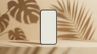 Smartphone with blank screen isolated on beige background with tropical plant shadows for app mockup and digital design projects.