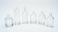 Clear glass bottles collection in various shapes and sizes isolated on white background for product packaging and cosmetic container design.