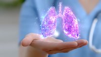 Medical professional holding glowing purple holographic lungs visualization, demonstrating advanced respiratory healthcare technology and innovative diagnostic approach.