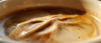 Creamy peanut butter swirl in bowl with rich, smooth texture and appetizing golden-brown color, suitable for food photography, culinary content, and recipe illustrations.