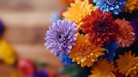 Vibrant chrysanthemum flowers in purple, orange, and blue colors create stunning floral arrangement against wooden background, perfect for seasonal celebrations.