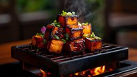 Grilled tofu cubes glazed with teriyaki sauce steaming on cast iron grill, garnished with green onions and sesame seeds, dramatic lighting highlights caramelized edges.