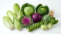 Fresh assorted cabbage varieties including napa, green, purple and savoy cabbages with brussels sprouts and bok choy isolated on white background for healthy cooking.