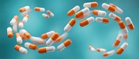 Orange and white pharmaceutical capsules floating in dynamic spiral formation against turquoise background for medical healthcare design projects.