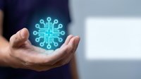 Businessman holding glowing digital circuit board symbol in cupped hands representing technology innovation and artificial intelligence solutions.