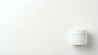 Minimalist white cosmetic jar with lid on a clean white background, showcasing elegant skincare packaging design for branding mockups.