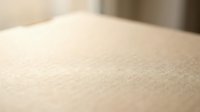 Close-up macro view of fine sand texture with soft focus background, natural beige color surface for spa wellness and relaxation concepts.