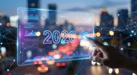 Businessman touching futuristic holographic interface displaying 2026 with digital network connections and data analytics over blurred city skyline at dusk.