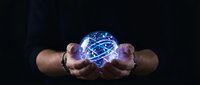 Male hands holding glowing digital brain with neural network connections on dark background for technology and artificial intelligence concepts.