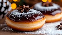 Chocolate glazed donut with star anise and powdered sugar dusting on wooden surface, warm bokeh lights in background, macro food photography.