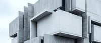 Modern concrete architectural structure with geometric cubic forms and industrial design elements for contemporary building projects.