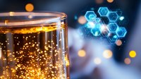 Glowing hexagonal molecular structure with glass of effervescent liquid and golden bokeh lights against blue background, science concept.