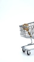 Wooden shopping bag icon inside miniature metal retail cart isolated on white background, representing e-commerce, online shopping, and consumer purchasing for retail design.