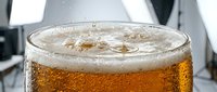Closeup of fizzy cola drink with ice cubes and bubbles in glass, carbonated beverage for advertising and food photography.