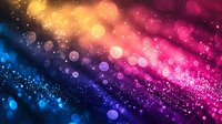 Vibrant multicolored bokeh lights with glowing particles creating magical abstract background in pink, purple, blue and golden hues for festive designs.